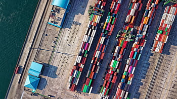 Top view of colorful shipping containers at a bustling port in Jakarta, Indonesia. HD wallpaper