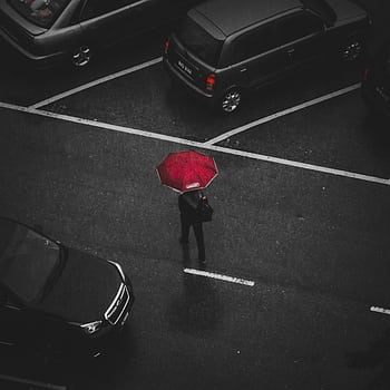 Top view of a person with a red umbrella walking in a rainy parking lot. HD phone wallpaper