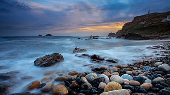 Stones Pebbles Sea Shore Island Mountain Under Blue Sky During Sunset Nature HD wallpaper