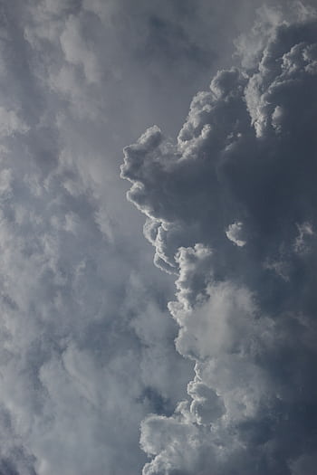 Stunning of a dramatic cloud formation against a deep blue sky, capturing the essence of nature's beauty. HD phone wallpaper