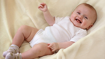 Smiling New Born Baby Is Lying Down On Textile Wearing White Dress Cute HD wallpaper