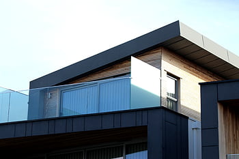 Contemporary building facade with sleek lines and glass elements in Poole, UK. HD wallpaper