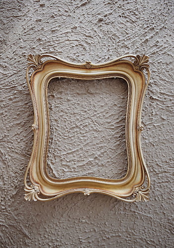 Antique golden frame with ornate details against a textured gray wall, perfect for art and design themes. HD phone wallpaper