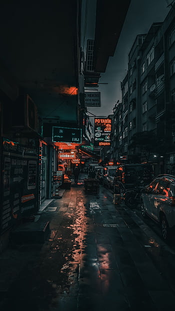 Dark urban street at night with glowing neon lights reflecting on wet pavement. HD phone wallpaper