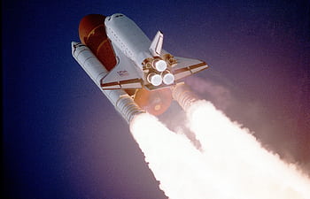 A space shuttle launches into space, showcasing powerful rocket engines and USA branding. HD wallpaper