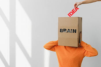 Surreal of a person with a cardboard brain, symbolizing idea and intellect. HD wallpaper