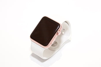 Stylish rose gold smart watch with a white band on a minimalist white background. HD wallpaper