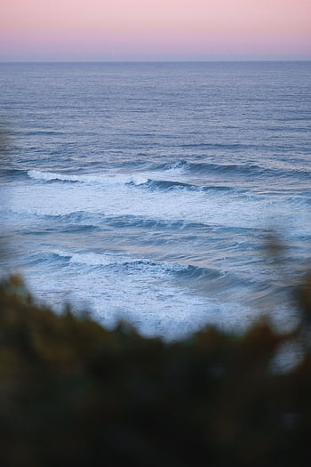 Captivating view of ocean waves at sunset near Robberg, South Africa. HD phone wallpaper