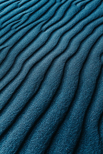 A vibrant blue sand texture with wavy patterns, ideal for backgrounds. HD phone wallpaper