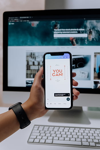 Hand holding smart with 'You Can!' message in front of screen. HD phone wallpaper