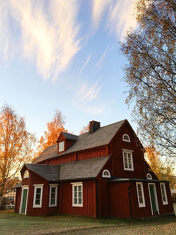 que red wooden house in autumn. Traditional Swedish architecture amidst colorful foliage. HD phone wallpaper