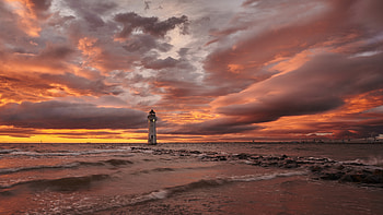 Lighthouse, ocean, sunset, beach HD wallpaper