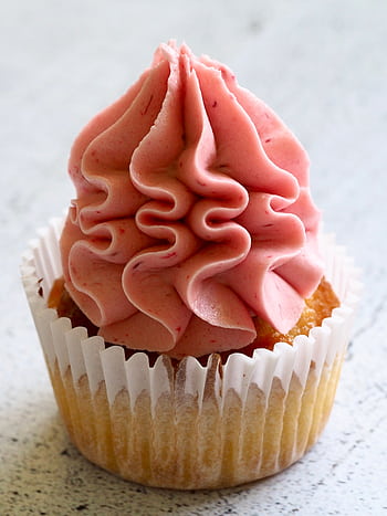 A pink frosted cupcake, perfect for dessert lovers, showcasing rich creamy swirls. HD phone wallpaper