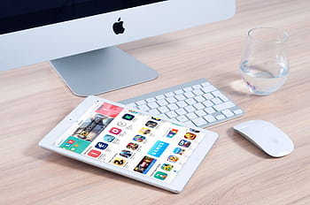 Sleek home office setup featuring an iMac and iPad showcasing apps. HD wallpaper