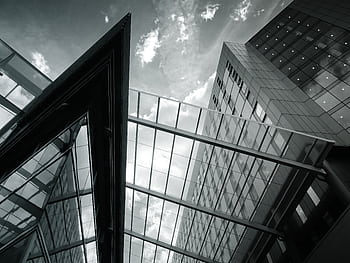 Low angle view of modern glass facade buildings showcasing contemporary architecture with reflections. HD wallpaper
