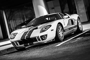 Monochrome of a sleek sports car parked, showcasing elegance and speed. HD wallpaper