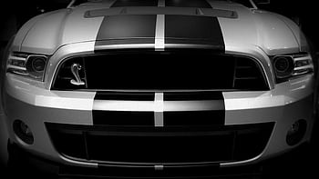 Front view of a classic sports car with racing stripes and sleek design, symbolizing speed and luxury. HD wallpaper