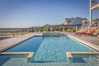 Stunning infinity pool at a seaside resort, perfect for relaxation and leisure travel. HD wallpaper