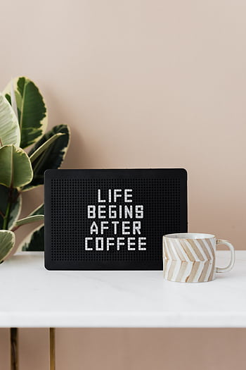 Cozy coffee setup with a motivational quote sign 'Life Begins After Coffee' and a striped mug. HD phone wallpaper