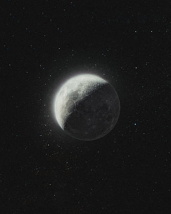 Captivating shot of the half moon glowing against a star-filled night sky with celestial charm. HD phone wallpaper