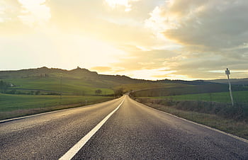 Beautiful empty road in Tuscany, Italy at sunset. Capturing the serene rural landscape and rolling hills. HD wallpaper