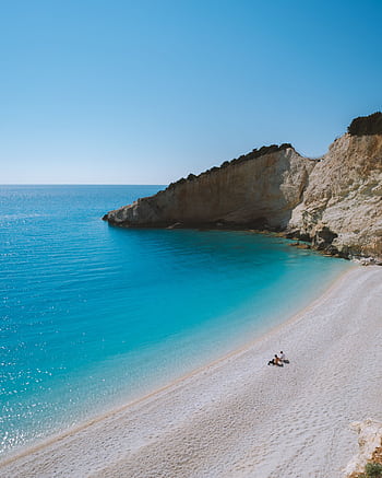 A breathtaking view of Porto Katsiki Beach in Lefkada, Greece, under the summer sun. HD phone wallpaper