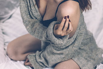 Intimate portrait of a woman in a sweater indoors, creating a warm and cozy vibe. HD wallpaper