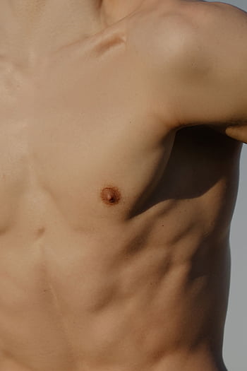 Close-up shot of a muscular male torso highlighting skin texture and muscle definition. HD phone wallpaper
