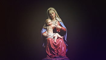A beautifully crafted statue depicting Mary holding child Jesus, showcasing religious art and devotion. HD wallpaper