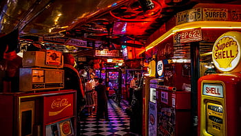 Vintage arcade bar with retro signs, people, and neon lights. HD wallpaper