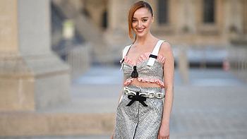 Smiling Phoebe Dynevor Girl Model Is Standing In Blur Background Wearing Grey Dress Girls HD wallpaper