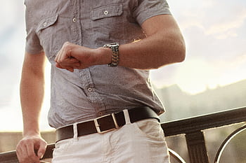 Close-up of an adult man checking his wristwatch outdoors. HD wallpaper