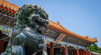 Close view of Foo Dog statue and traditional Chinese architecture at Beijing's Summer Palace. HD wallpaper