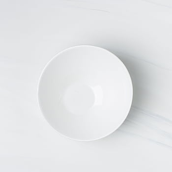 Top view of a white ceramic plate on a marble surface, showcasing minimalist design. HD phone wallpaper
