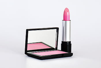Stylish pink lipstick and blush makeup set on a white background, perfect for beauty and cosmetics branding. HD wallpaper