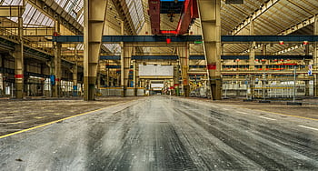 Wide view of an empty industrial warehouse with visible cranes and metal structures. HD wallpaper