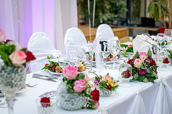 Beautifully decorated wedding table setting with floral arrangements and wine glasses, creating an elegant atmosphere. HD wallpaper