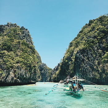 Explore El Nido's breathtaking lagoon with turquoise waters and lush cliffs, a perfect tropical getaway. HD phone wallpaper