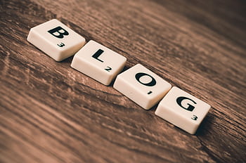 Scrabble tiles spelling 'BLOG' on a wooden background, symbolizing creativity and writing. HD wallpaper