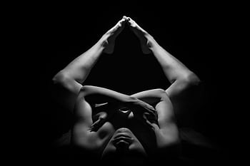 Black and white graph showcasing an artistic nude pose with dramatic lighting and shadows. HD wallpaper