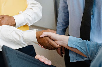 Close-up view of a diverse business handshake signaling cooperation and partnership. HD wallpaper