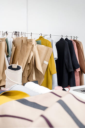 A vibrant display of fabrics and designs in a modern fashion studio. HD phone wallpaper