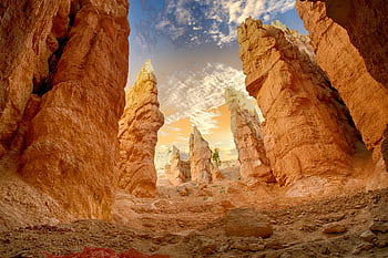 Breathtaking view of towering sandstone formations under a dramatic sky, showcasing natural erosion. HD wallpaper