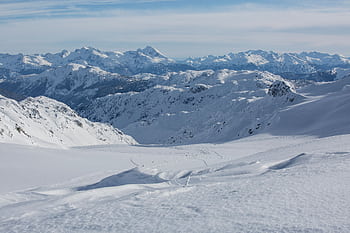 Stunning high-altitude view of snow-covered Canadian mountains on a crisp winter day. HD wallpaper