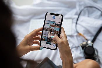 A person interacts with a smart displaying social media content in Bali, Indonesia. HD wallpaper