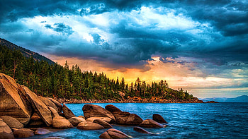 A summer sunset on Lake Tahoe with a luminous glow in the east., california, colors, rocks, usa, trees, clouds, sky, water, forest HD wallpaper