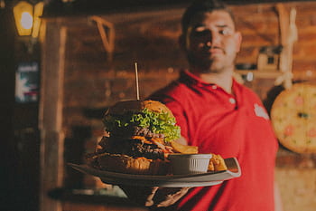 Delicious gourmet burger with fries served indoors at a restaurant in Brazil. HD wallpaper