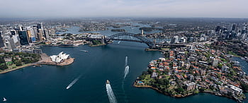 Stunning aerial view capturing Sydney Opera House and Harbour Bridge in daylight. HD wallpaper