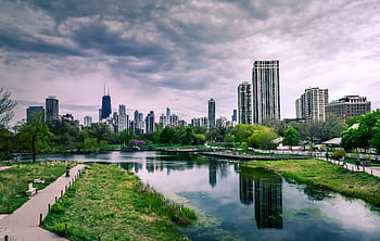 Dramatic view of Chicago skyline with reflections over Lincoln Park Lagoon on a cloudy day. HD wallpaper