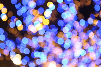 Colorful bokeh lights forming an abstract pattern. Perfect for festive or artistic backgrounds. HD wallpaper